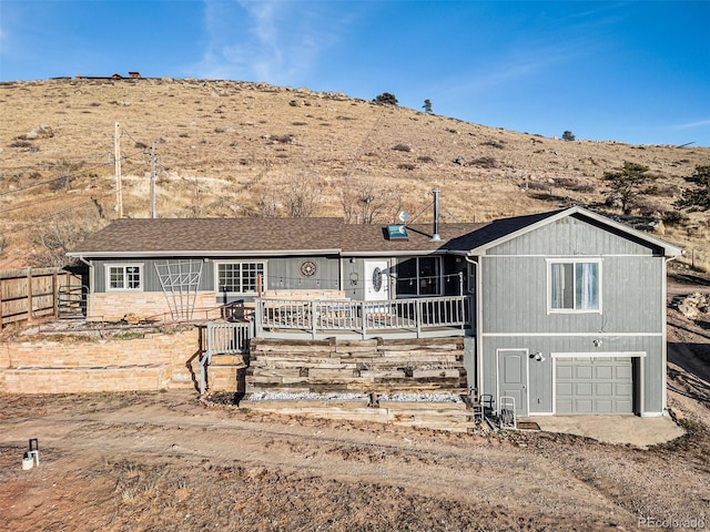 single story home featuring a mountain view and a garage