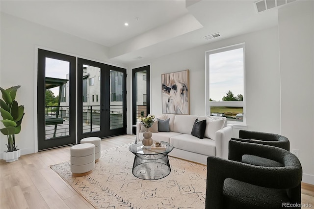 living room with light hardwood / wood-style floors and french doors