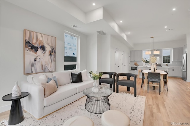 living room featuring light hardwood / wood-style flooring and a chandelier