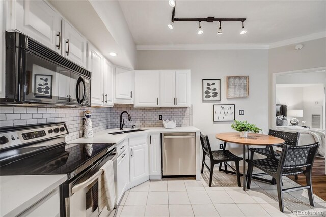 601 W 11th Ave Unit 1101, Denver, CO 80204 - kitchen with appliances with stainless steel finishes, a sink, light countertops, crown molding, and decorative backsplash