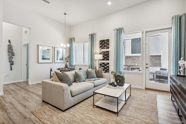 487 Interlocken Blvd Unit 106, Broomfield, CO 80021 - living room with a chandelier, light wood-style flooring, and baseboards