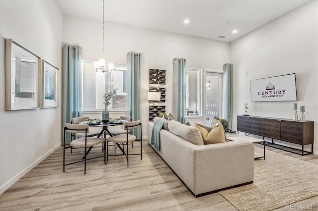 487 Interlocken Blvd Unit 106, Broomfield, CO 80021 - living area with a chandelier, light wood-style floors, healthy amount of natural light, recessed lighting, and baseboards