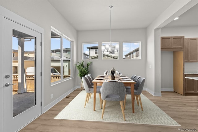 21202 E 63rd Dr, Aurora, CO 80019 - dining room with baseboards, light wood finished floors, and a wealth of natural light
