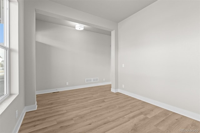 21202 E 63rd Dr, Aurora, CO 80019 - spare room featuring light wood-style floors, a healthy amount of sunlight, baseboards, and visible vents