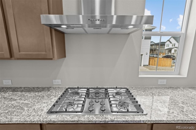 21202 E 63rd Dr, Aurora, CO 80019 - kitchen with exhaust hood, light stone counters, and stainless steel gas stovetop