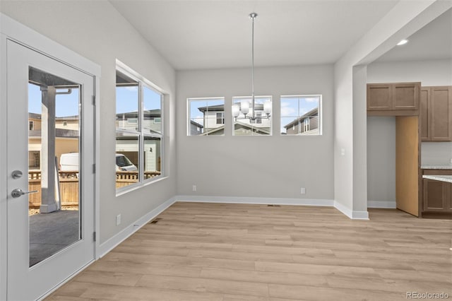 21202 E 63rd Dr, Aurora, CO 80019 - unfurnished dining area with a healthy amount of sunlight, baseboards, and light wood finished floors