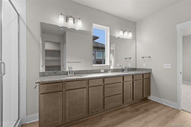 21202 E 63rd Dr, Aurora, CO 80019 - full bathroom featuring a sink, wood finished floors, and a shower stall