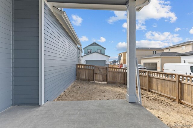 21202 E 63rd Dr, Aurora, CO 80019 - view of patio featuring a residential view and a fenced backyard