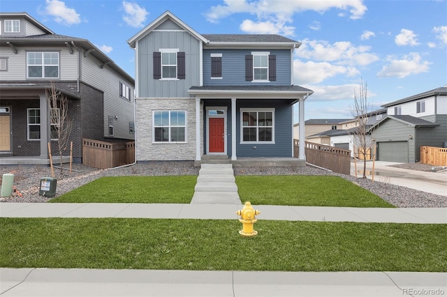 21202 E 63rd Dr, Aurora, CO 80019 - view of front of property featuring fence, board and batten siding, a front lawn, and stone siding