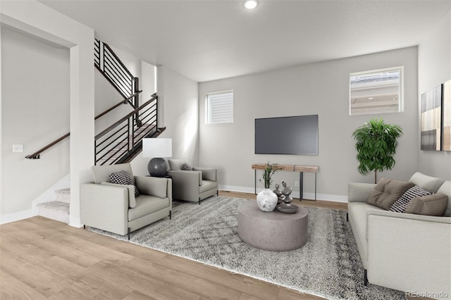 21202 E 63rd Dr, Aurora, CO 80019 - living area featuring baseboards, wood finished floors, and stairway