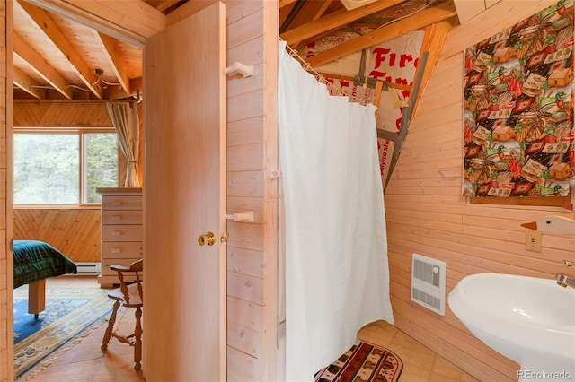 902 Hawk Way, Jefferson, CO 80456 - full bath with wooden walls, a sink, baseboard heating, and a shower with shower curtain