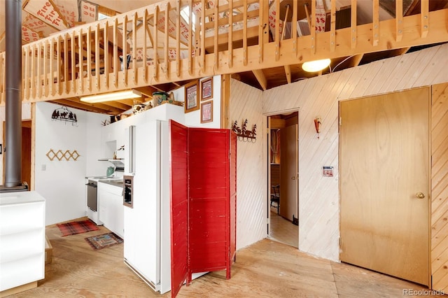 902 Hawk Way, Jefferson, CO 80456 - kitchen featuring stove, white fridge with ice dispenser, wood finished floors, wood walls, and open shelves