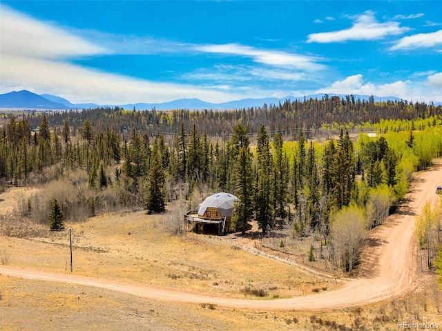 902 Hawk Way, Jefferson, CO 80456 - view of mountain backdrop with a forest