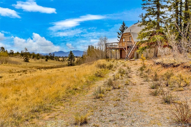 902 Hawk Way, Jefferson, CO 80456 - view of yard with a deck with mountain view and stairs