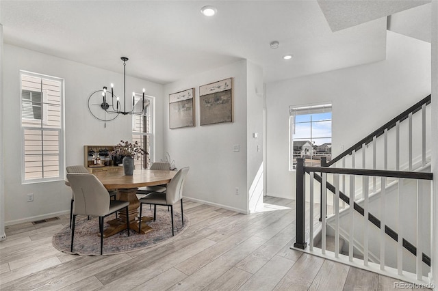 dining area with visible vents, baseboards, light wood-style floors, a notable chandelier, and recessed lighting