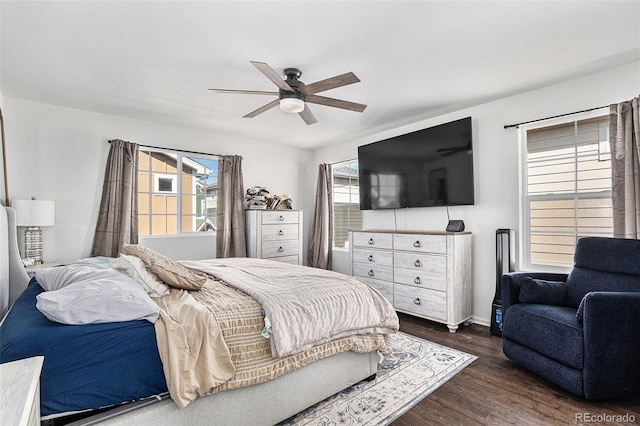 bedroom featuring dark wood-style flooring, ceiling fan, and baseboards