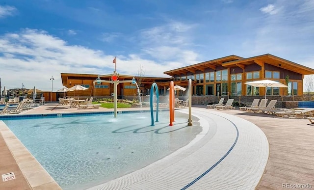 view of swimming pool featuring a patio area and fence