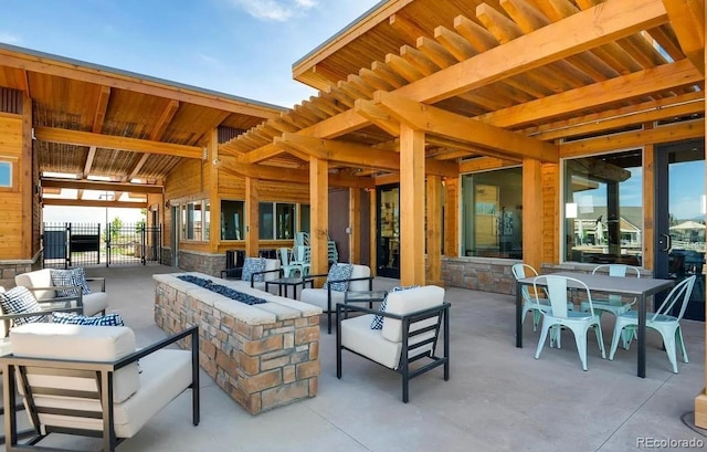 view of patio / terrace featuring outdoor dining space, an outdoor living space with a fire pit, and fence