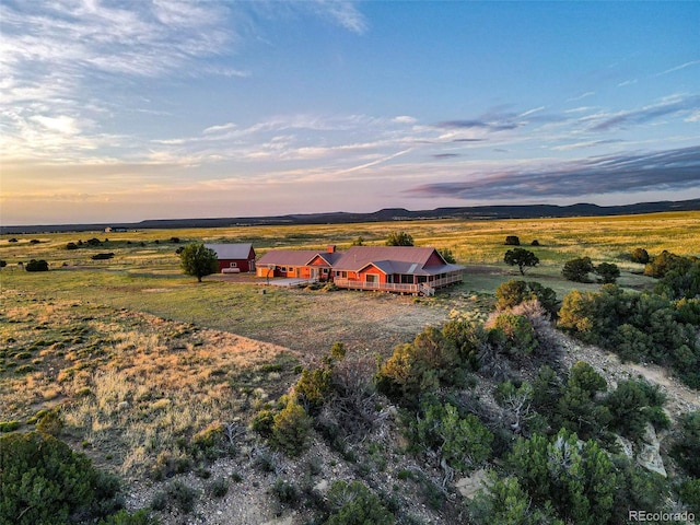 aerial view at dusk featuring a rural view