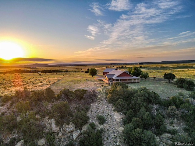 aerial view at dusk featuring a rural view