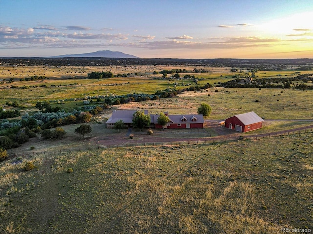 aerial view at dusk featuring a rural view