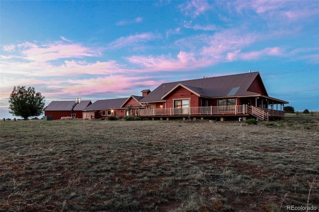 view of front of home with a yard and a wooden deck