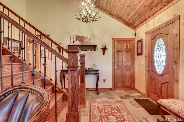 foyer entrance featuring an inviting chandelier, lofted ceiling, light tile patterned floors, and wood ceiling