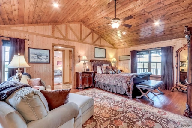 bedroom featuring multiple windows, hardwood / wood-style flooring, high vaulted ceiling, and ceiling fan