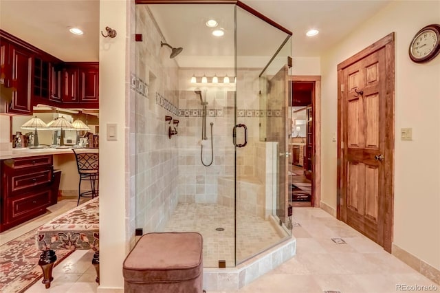 bathroom featuring tile patterned floors and a shower with door