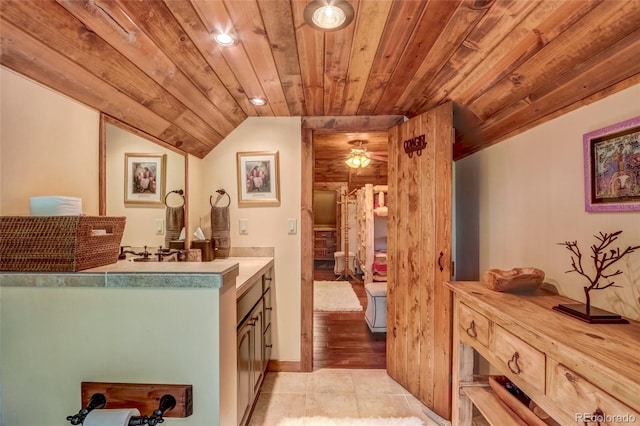 kitchen featuring wooden ceiling, light tile patterned floors, vaulted ceiling, and ceiling fan