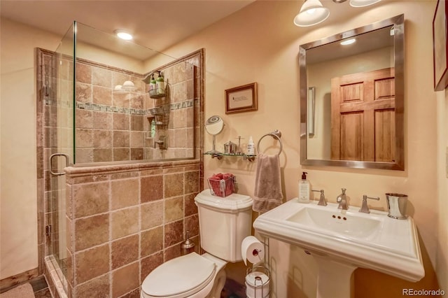 bathroom featuring toilet and walk in shower