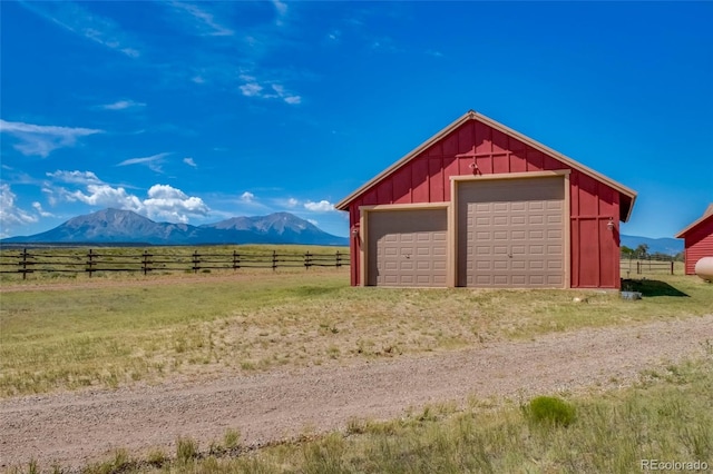 garage with a mountain view and a rural view