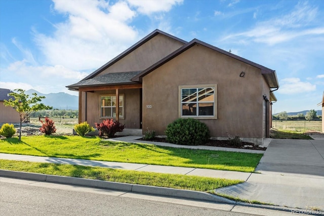 133 Starbuck Cir, Salida, CO 81201 - view of front of home featuring a mountain view, a front yard, stucco siding, and driveway