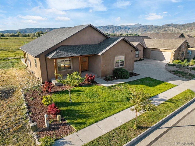 133 Starbuck Cir, Salida, CO 81201 - single story home featuring roof with shingles, concrete driveway, a front lawn, a garage, and a mountain view