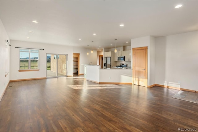 133 Starbuck Cir, Salida, CO 81201 - unfurnished living room with wood finished floors and recessed lighting