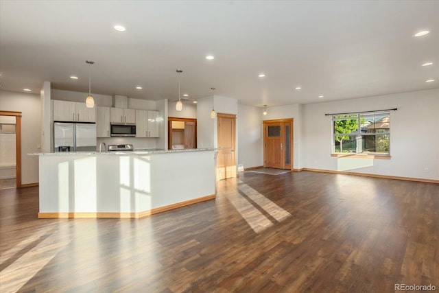 133 Starbuck Cir, Salida, CO 81201 - kitchen with stainless steel appliances, recessed lighting, dark wood finished floors, a large island with sink, and hanging light fixtures