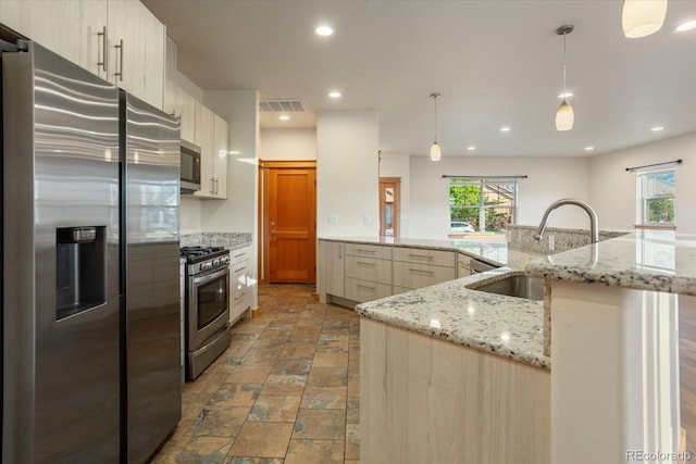 133 Starbuck Cir, Salida, CO 81201 - kitchen featuring stainless steel appliances, stone finish flooring, hanging light fixtures, recessed lighting, and light stone countertops
