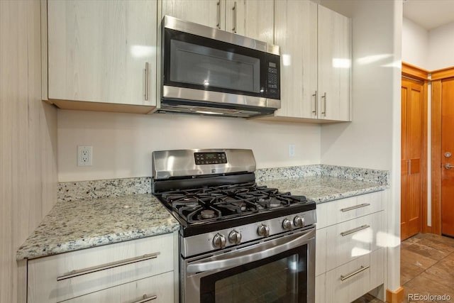 133 Starbuck Cir, Salida, CO 81201 - kitchen featuring stainless steel appliances, modern cabinets, light stone counters, and light brown cabinets