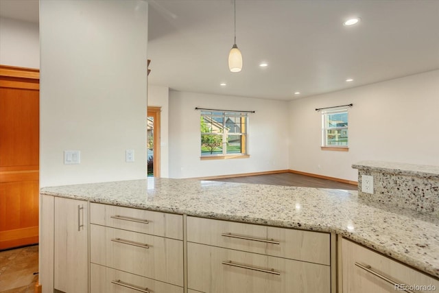 133 Starbuck Cir, Salida, CO 81201 - kitchen with light brown cabinetry, light stone counters, hanging light fixtures, and recessed lighting