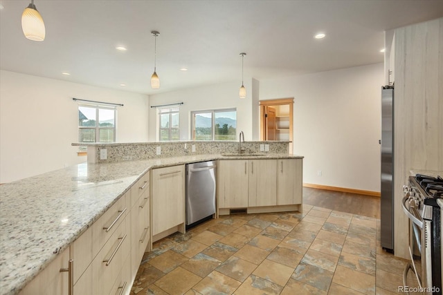 133 Starbuck Cir, Salida, CO 81201 - kitchen featuring appliances with stainless steel finishes, light brown cabinets, light stone counters, recessed lighting, and hanging light fixtures