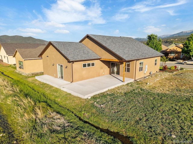 133 Starbuck Cir, Salida, CO 81201 - rear view of house with a patio, stucco siding, a lawn, and a mountain view