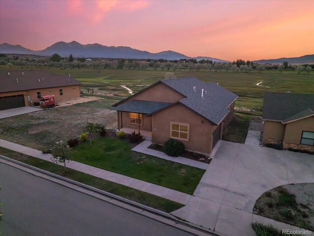 133 Starbuck Cir, Salida, CO 81201 - view of front facade featuring a mountain view, concrete driveway, a shingled roof, an attached garage, and a lawn