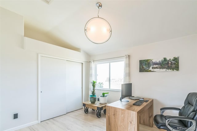 office space with lofted ceiling and light wood-style floors
