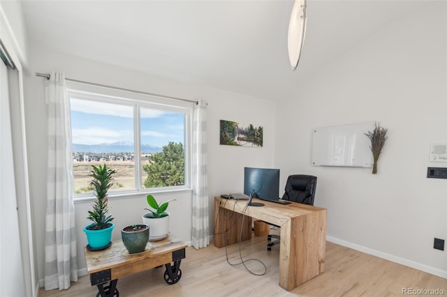 office area with vaulted ceiling, wood finished floors, and baseboards