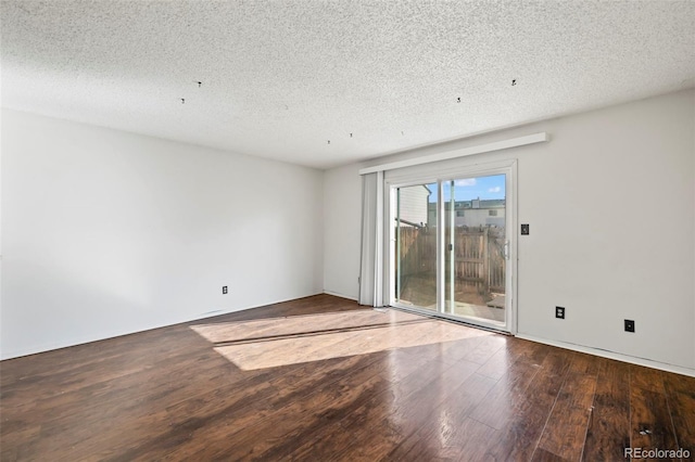 spare room with a textured ceiling and hardwood / wood-style floors