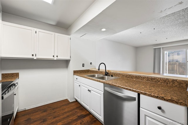 kitchen with white cabinets, stainless steel appliances, sink, dark stone counters, and dark wood-type flooring