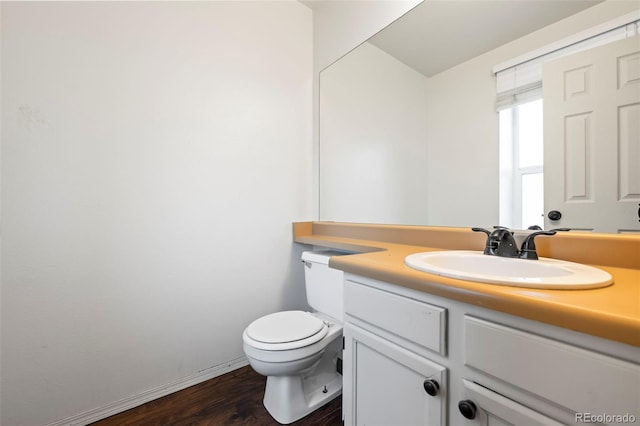 bathroom with vanity, toilet, and wood-type flooring