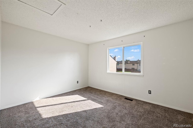 carpeted spare room featuring a textured ceiling