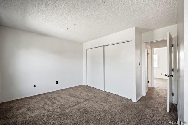 unfurnished bedroom with a closet, a textured ceiling, and carpet floors