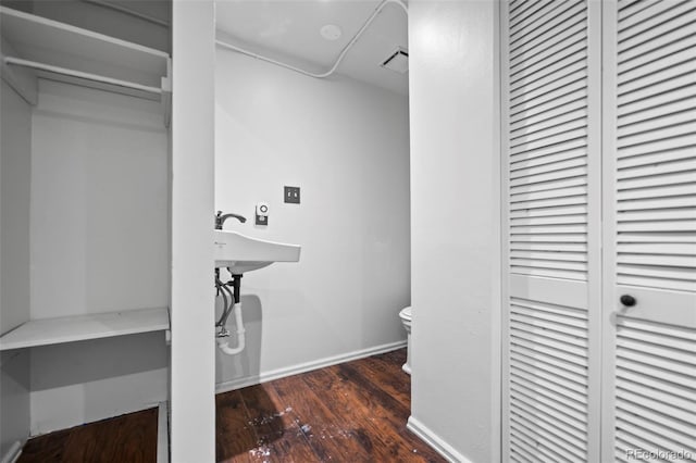 bathroom featuring toilet and hardwood / wood-style flooring